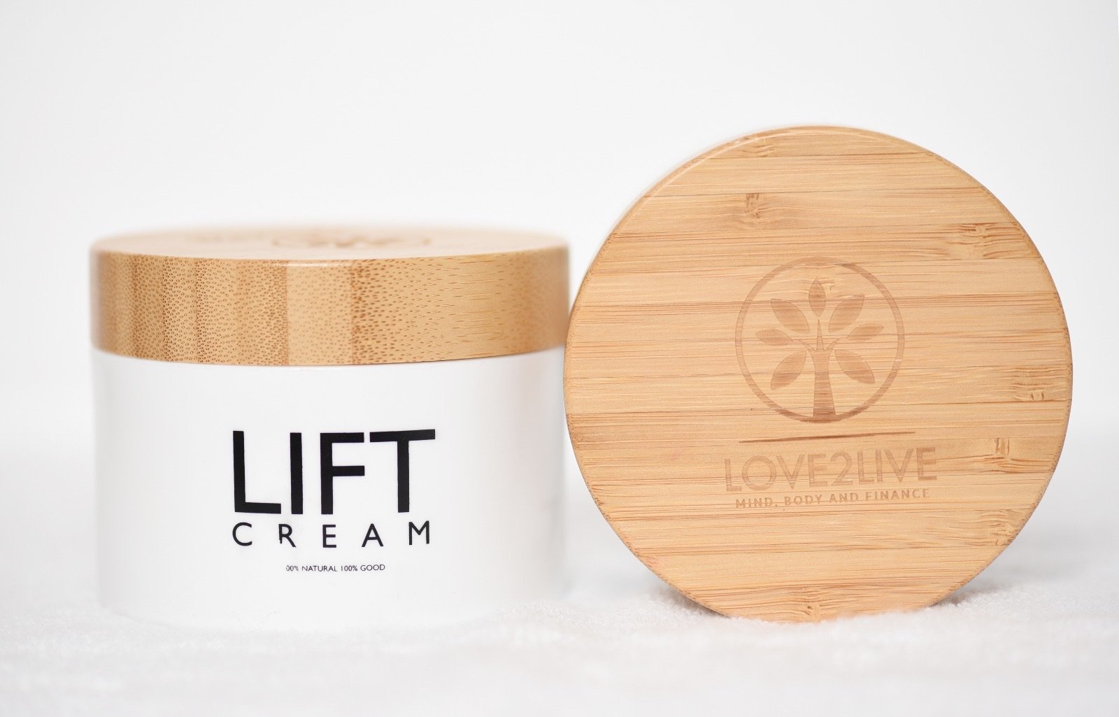 LIFT Cream jar beside its engraved bamboo lid